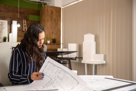 Young Woman Architect Who Controls Sketches Real Estate Project Cozy Work Place