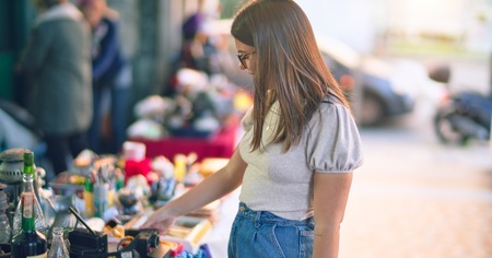 Young Beautiful Woman Smiling Happy Confident Standing With Smile Face Looking Jumble Sale Town Street